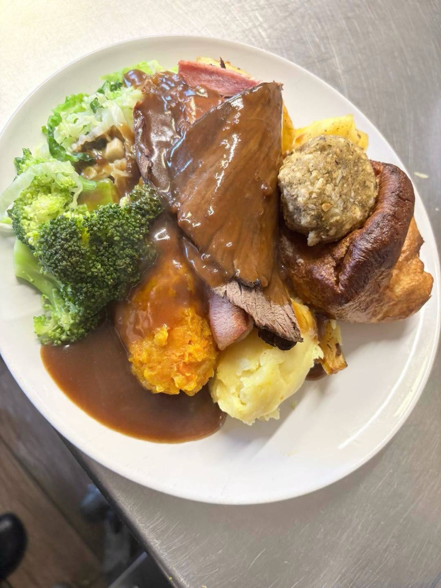 Roast beef dinner with gravy, stuffing and vegetables