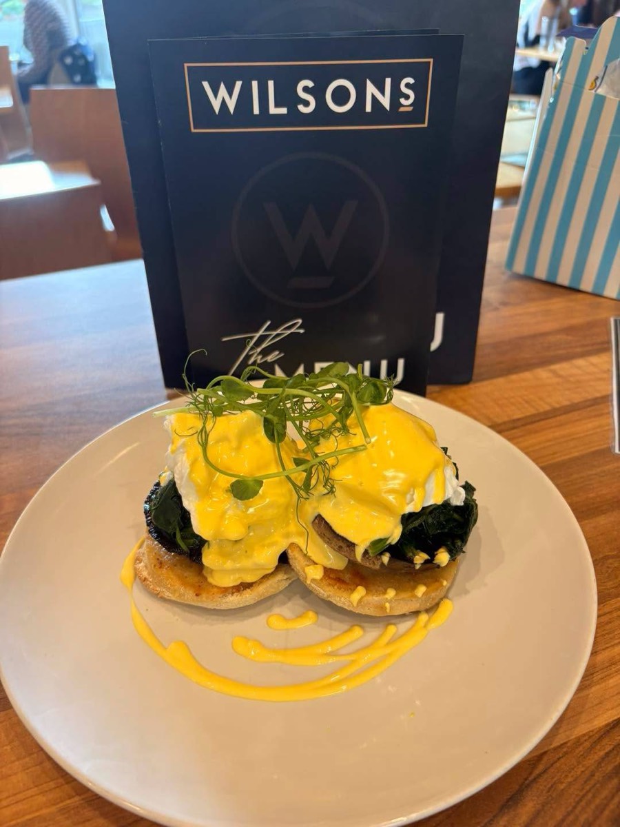 Eggs Benedict with hollandaise next to the menu